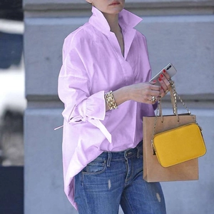 Detailed view of lavender puff sleeves with delicate tie-knot cuffs on a summer blouse