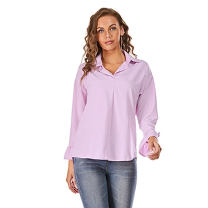Detail of lavender long sleeve blouse with ruffled cuffs and elegant lapel neckline