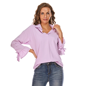 Detail of lavender blouse showing long sleeves with ruffled cuffs and bow ties
