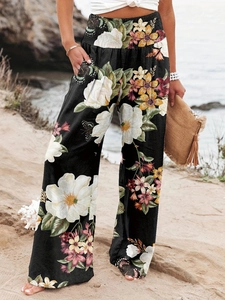 Detail of high waisted wide leg pants with floral and butterfly prints for beach vacation