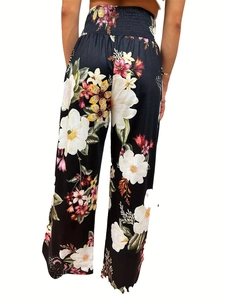 Back view of high waist wide leg trousers featuring a bold tropical floral print