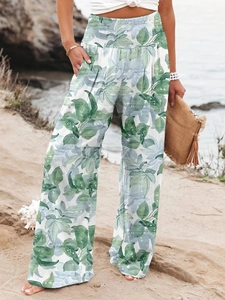 Detail of high waist elastic waistband on tropical leaf print wide leg trousers