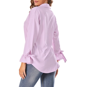 Detail of light purple chiffon shirt showing bow-knot cuffs and curved hemline