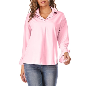 Detail of light pink long sleeve shirt showing ruffle cuffs and v-neck collar design