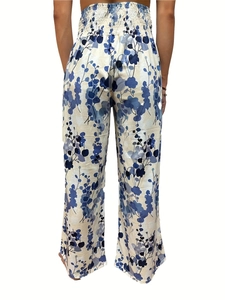 Detail view of high waisted wide leg pants featuring smocked waist and blue floral print