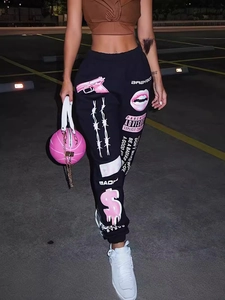 Women's black joggers with pink graphic prints including pistols and lips for street style