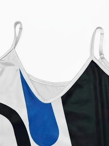Detail of V-neckline and adjustable spaghetti straps on blue and white colorblock dress