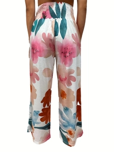 Rear view of high waisted floral wide leg trousers with elastic pleated waistband