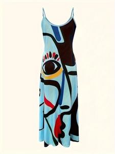 Detail of artistic pop art print on light blue summer dress with eye and face motifs