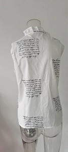 Detail view of the back of a sleeveless ruffle collar blouse with script text print