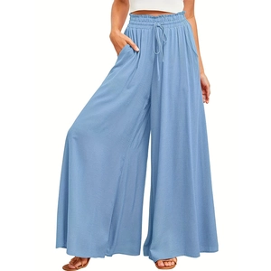 Detail of light blue high-waist palazzo pants with paperbag waist and drawstring tie