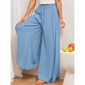 Detail of high waist elastic drawstring on light blue wide leg trousers for women