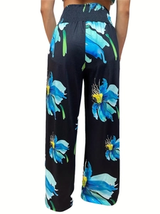 Back view of high waisted wide leg pants with vibrant floral print and elastic waist