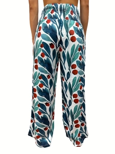 Detail view of high-waist floral wide-leg pants with navy leaves and red berries