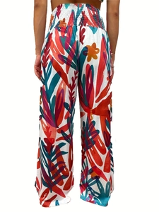 Detail of high waist smocked elastic waistband on tropical print wide leg trousers