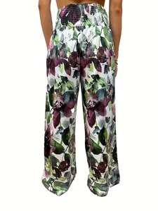 Detail of high waisted wide leg trousers with floral print and elastic smocked waistband