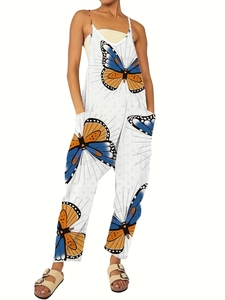 Detail of loose white jumpsuit featuring vibrant blue and orange butterfly prints and side pockets