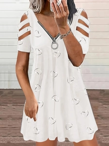 Close-up of V-neck with metal zipper and hollow-out sleeves on white heart print dress