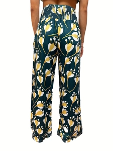 Detail of high waisted wide leg pants with dark green floral pattern and smocked waist