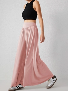 Vue dynamique du pantalon de danse rose à taille haute avec une texture satinée soyeuse