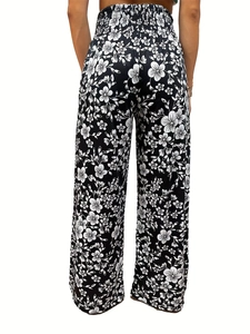 Detail of high waist elastic waistband on floral wide-leg pants for women