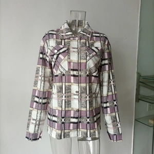 Detail of plaid shirt jacket with buttoned chest pockets and purple checkered pattern