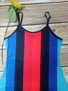 Close-up of colorful vertical stripe pattern and fine spaghetti straps on a summer dress