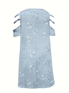 Detail of cold shoulder design with decorative straps on light blue heart print dress