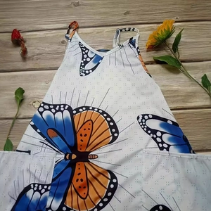 Women's white sleeveless wide-leg jumpsuit featuring bold butterfly print and pockets