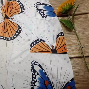 Summer sleeveless wide-leg jumpsuit with colorful butterfly prints and pocket detail