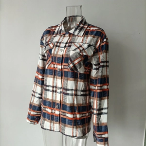 Detail of classic plaid shirt with orange and blue check pattern and chest flap pockets