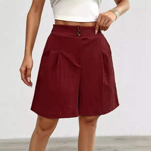 Detail of high-waisted wide-leg shorts in wine red with ribbed texture and double buttons