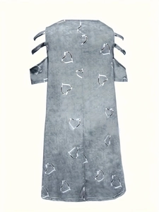 Detail of grey V-neck dress featuring cold-shoulder cutouts and white heart patterns