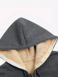 Close-up of deep gray hoodie featuring thick cream sherpa lining and metal zipper detail