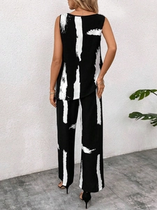 Rear view of long sleeveless tunic and wide-leg trousers in black and white abstract print