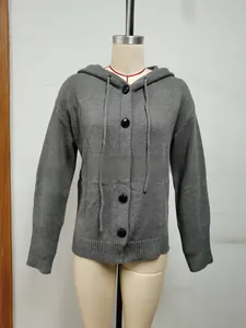 Detail view of grey hooded cardigan featuring large black buttons and ribbed texture