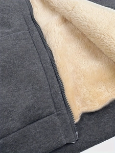 Detail of warm faux fur lining and sturdy resin zipper on dark grey plus size hoodie