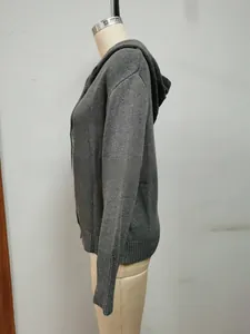 Detail of dark grey hooded cardigan showing fine knit texture and ribbed cuffs