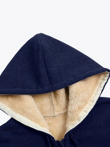Detail of warm navy blue hoodie showing thick beige sherpa lining and zipper