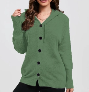 Detail of green knitted cardigan with large black buttons, drawstring hood and ribbed cuffs