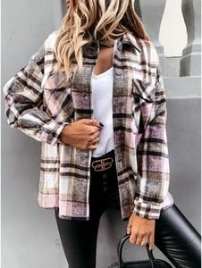 Detail of pink plaid wool shirt jacket showing textured fabric and silver button closure
