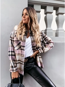 Close-up of pink plaid shacket featuring front flap pockets and metallic buttons