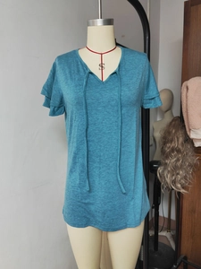 Detail view of peacock blue V-neck T-shirt with layered ruffle sleeves and ties