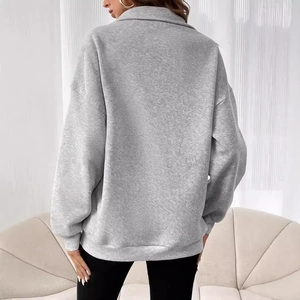 Back view of a grey oversized fleece sweatshirt with a lapel collar and ribbed cuffs