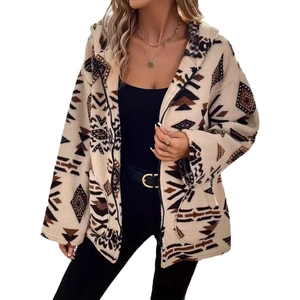 Detailed view of beige fleece hoodie with dark brown geometric tribal print texture