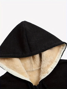 Detail of black hoodie with thick beige faux sherpa lining and soft knit fabric texture