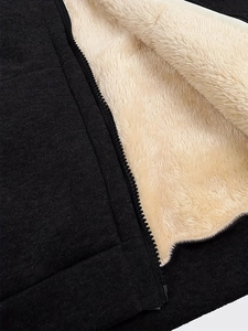 Detailed close-up of dark grey hoodie showing warm beige sherpa fleece lining and zipper