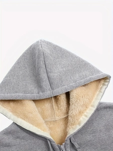Close-up of a grey hoodie showing the warm brown fleece lining and metal zipper detail