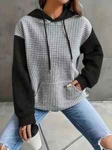 Men's loose color block hoodie with grey waffle knit body and black textured sleeves