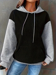 Detail of color block hoodie featuring waffle texture fabric and kangaroo pocket